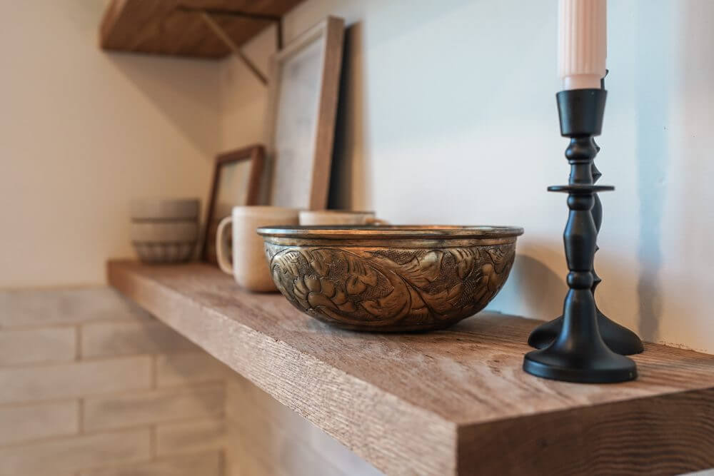 Home decor styled on a wooden shelf