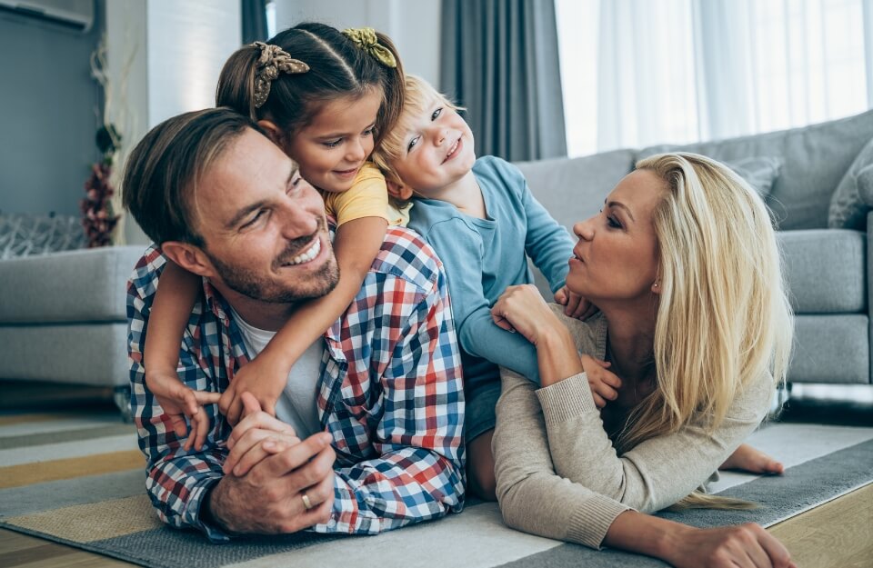 Happy family laughing together on the couch